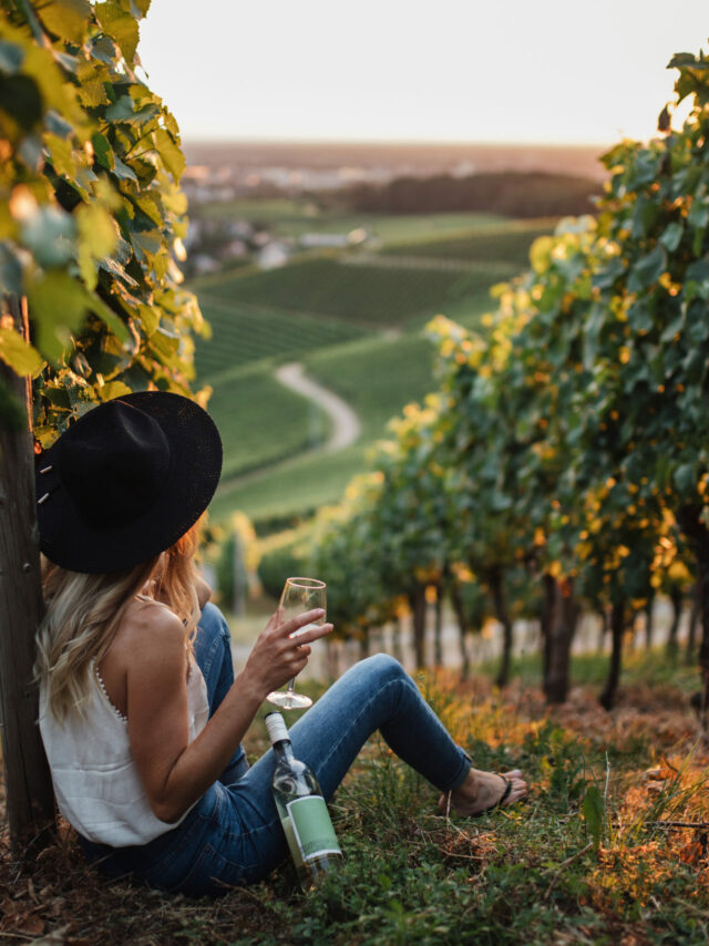 young-blonde-woman-relaxing-vineyards-summer-season-with-bottle-wine